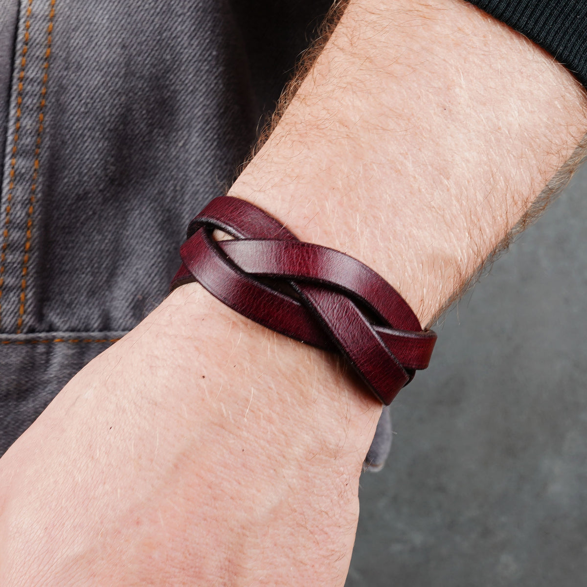 Close wrist view with the bracelet crossing over denim