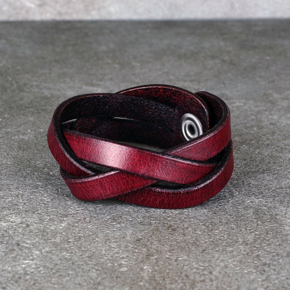 Front view of the bracelet showing the layered strap weave and metal snap