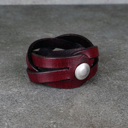 Side view of the bracelet showing the overlapping leather strips