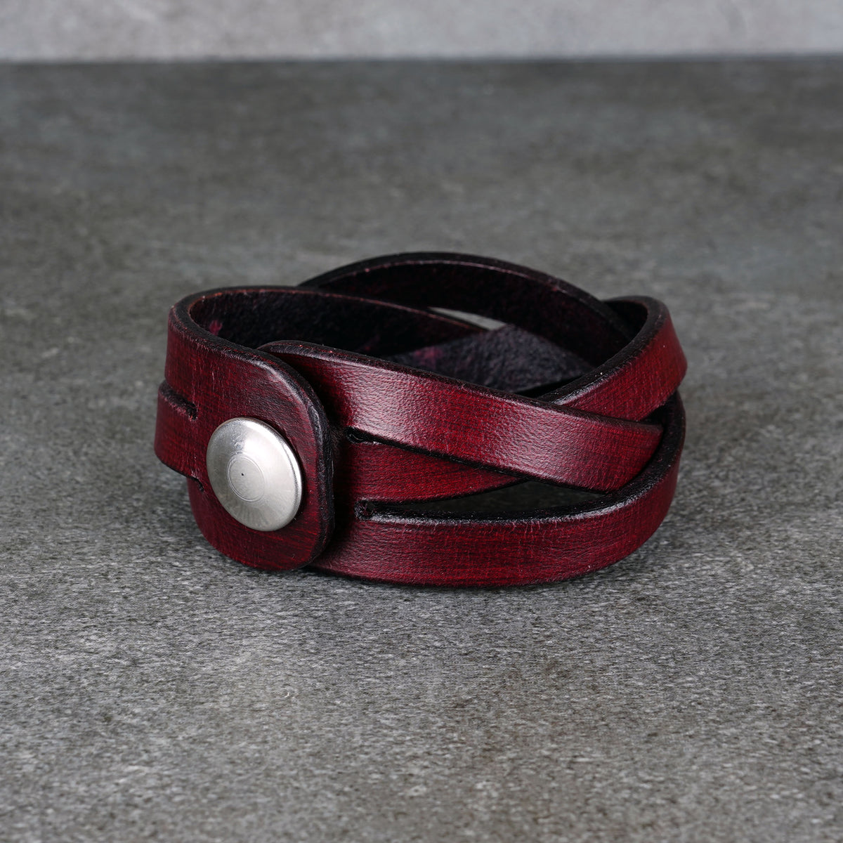 Worn bracelet from a front angle showing the strap crossing details