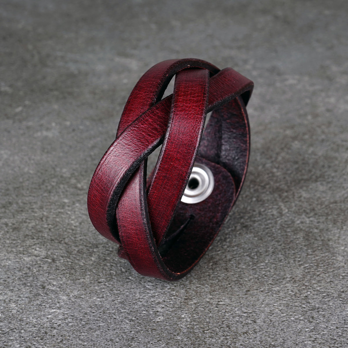 Close-up of the bracelet’s looped strap pattern with the snap partly visible