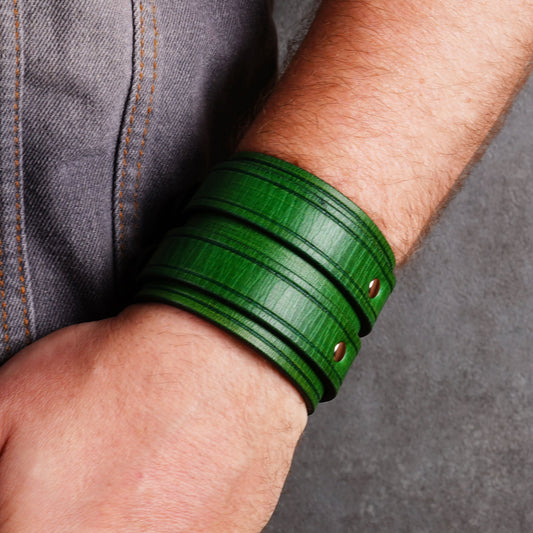 Close side view of a green leather cuff bracelet worn on a wrist
