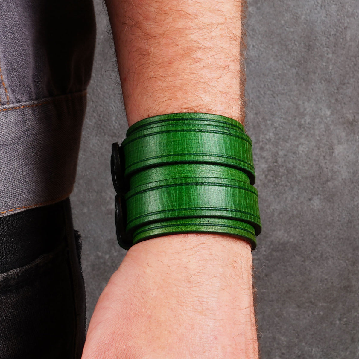 Front-facing wrist view of a green cuff bracelet with the buckle hidden