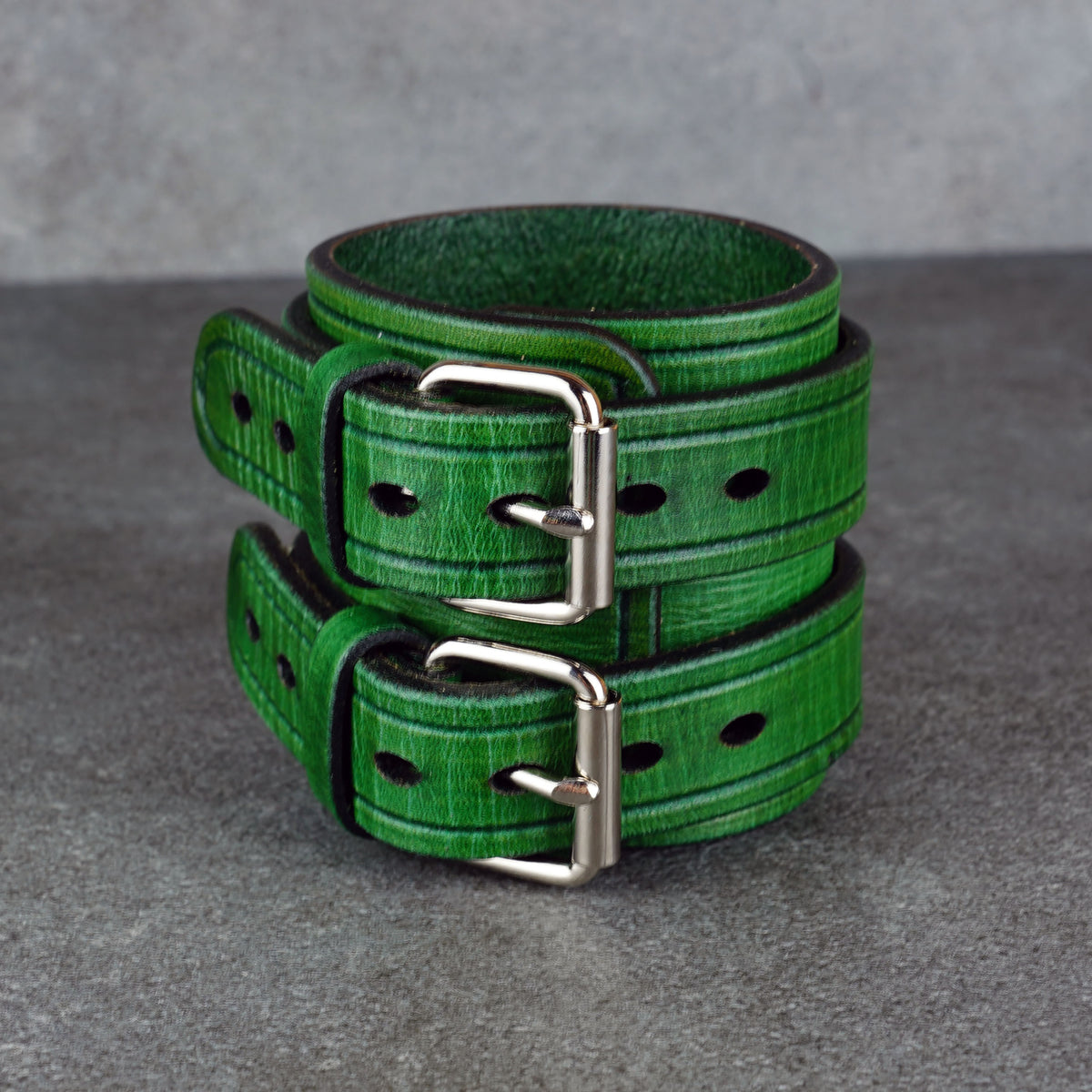 Close studio view of the green cuff bracelet showing the open cuff and buckle side