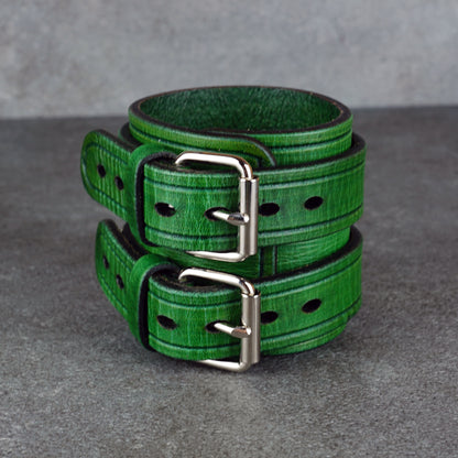 Close studio view of the green cuff bracelet showing the open cuff and buckle side